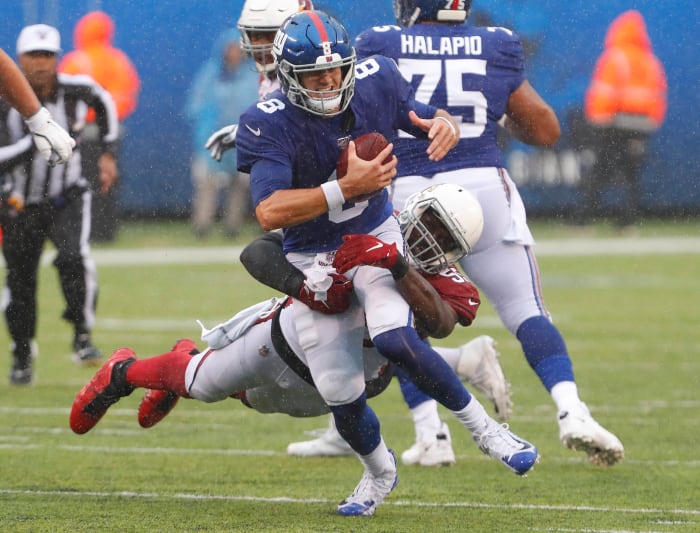 Giants quarterback Daniel Jones (8) is tackled by Cardinals linebacker Chandler Jones (55) during the second half of a 2019 game at MetLife Stadium.